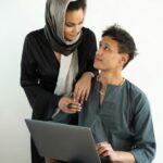 Mother and son studying on the computer.