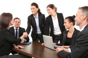 Smiling coworkers around a conference table.