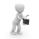 "Any Man" holding a clapboard.