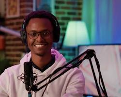 Person speaking confidently into microphone during a podcast in studio.