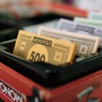 Detailed view of Monopoly game money and box, ready for family game night.