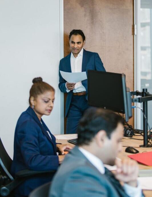 Business professionals collaborating in a modern office setting, focused on team success.