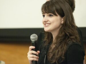 Public speaker delivering a speech using a microphone to practice enunciation.