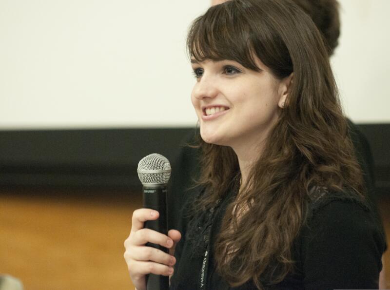 Public speaker delivering a speech using a microphone to practice enunciation.