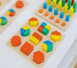 Colorful fraction blocks that fit into puzzle holes.