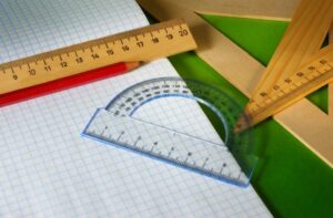 Grid paper, rulers, and protractor – ready for drawing geometric shapes.