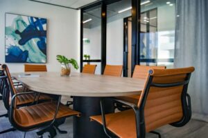 Professional presenting meeting room with a brown table and 8 chairs.