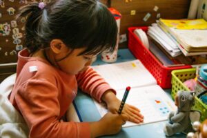 A young student eagerly solving a math puzzle.