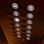 Elevator floor button panel showing floor numbers inside an apartment building.