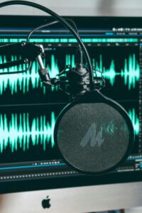 Microphone and audio sound wave representing speech recording and accent reduction practice.