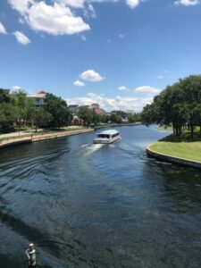 Pontoon boat on a calm lake illustrating linear algebra cost scenarios.
