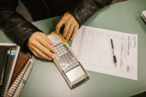 High school student solving algebra word problems with a graphing calculator for SAT prep.