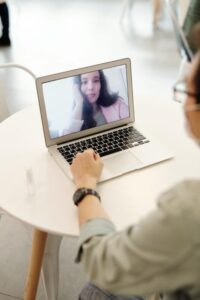 Professional speech coach guiding a student on accent reduction techniques and mouth placement.