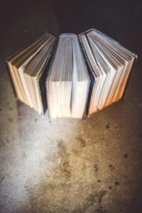 A set of three books displayed in a fanned out fashion.