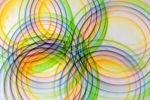Vibrant abstract design featuring overlapping multicolored circular light patterns.