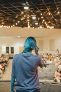 A young lady in front of a group of her peers and fighting her fear of public speaking.